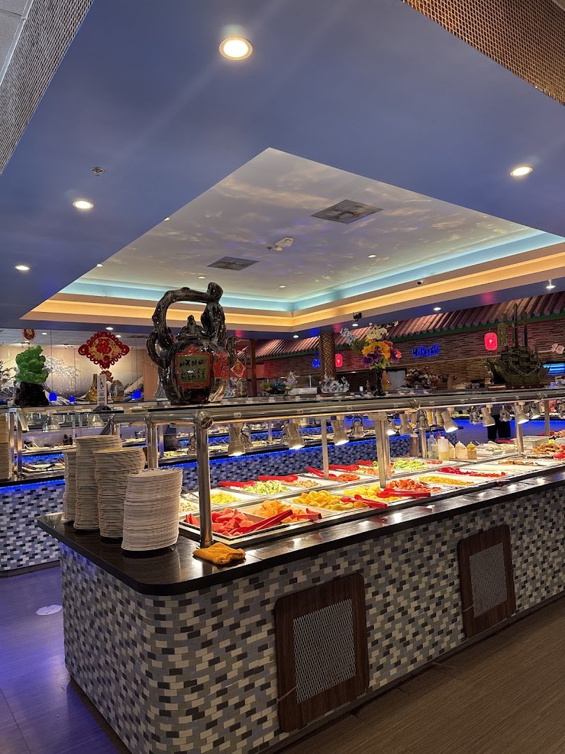 Indoor seating beside a busy buffet line.